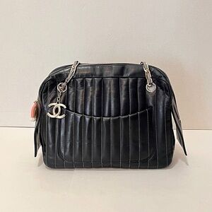 CHANEL Black Quilted Leather Shoulder Bag with CC Charm and Front Pockets